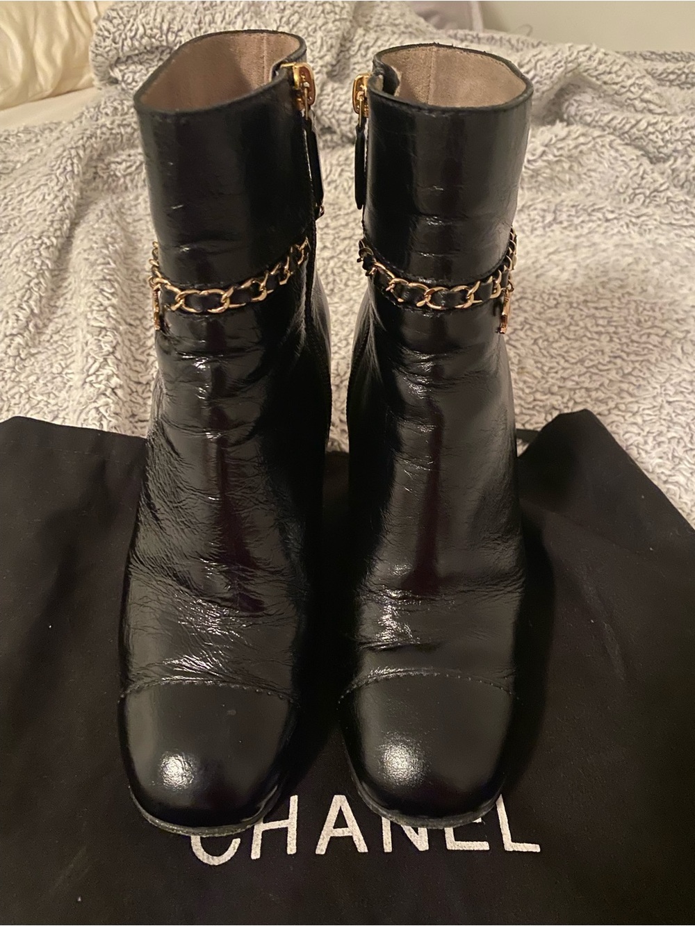 CHANEL Black Patent Leather Ankle Boots with Gold Chain Accent